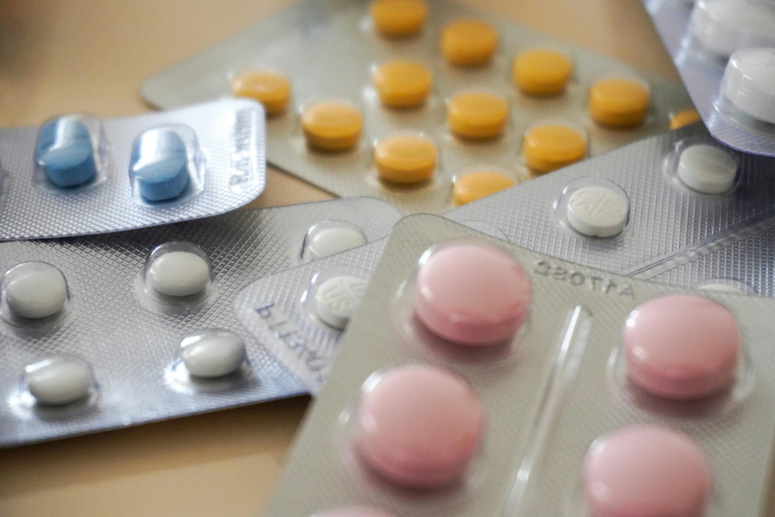 Close-up view of assorted colorful medication blister packs with diverse pills.